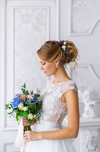 istock Bride holding blue wedding bouquet 610555856