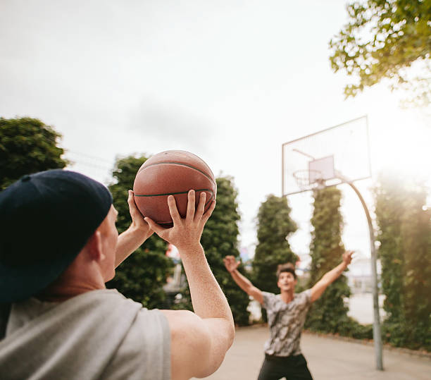 istock Friends playing basketball against each other 610555914