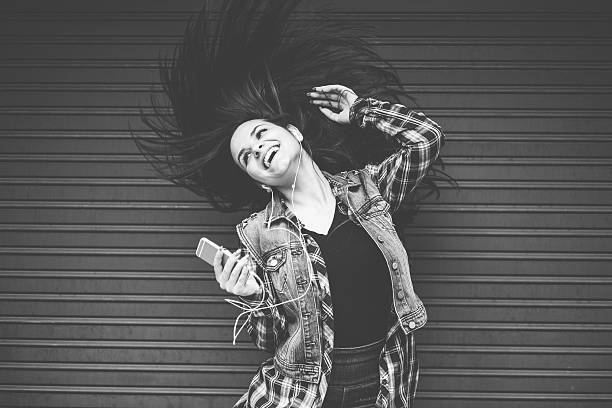Young woman tossing hair and dancing on the music