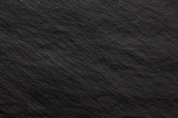 Photo of Dark black slate background or texture