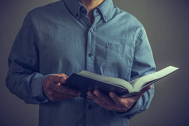 istock Pastor or preacher with the Bible on his hands 610558986