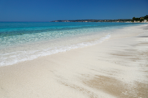 Empty Lourdas sandy beach with crystalline sea on Greek's island of Kefalonia.