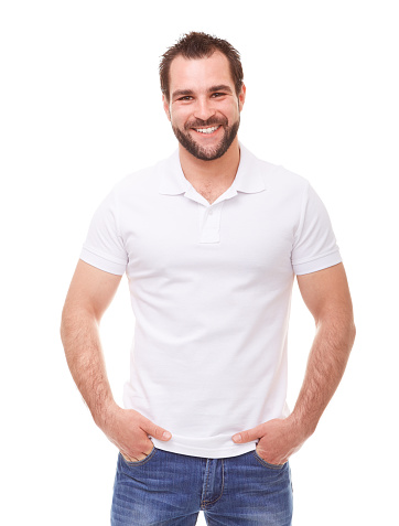 Happy man in a white polo shirt with hands in pockets
