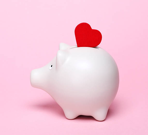 istock Piggy bank with red heart shape 610560000