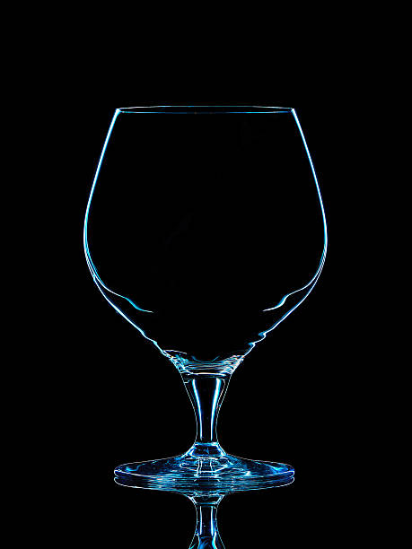 istock Silhouette of blue whiskey glass with clipping path on black 610564514