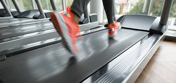 Exercise treadmill cardio running workout at fitness gym of woman taking weight loss with machine aerobic for slim and firm healthy in the morning.
