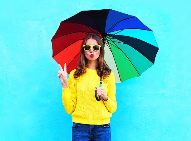Photo of pretty cool woman with colorful umbrella in autumn over blue