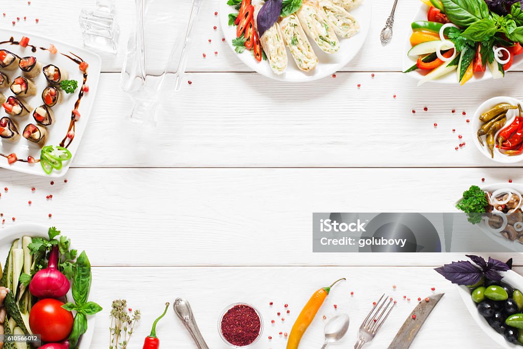 Food frame on white wooden table, free space Food frame on white wooden table, free space. Top view on white wooden table with different snacks and copy space for text. Food, menu, cuisine concept Backgrounds Stock Photo