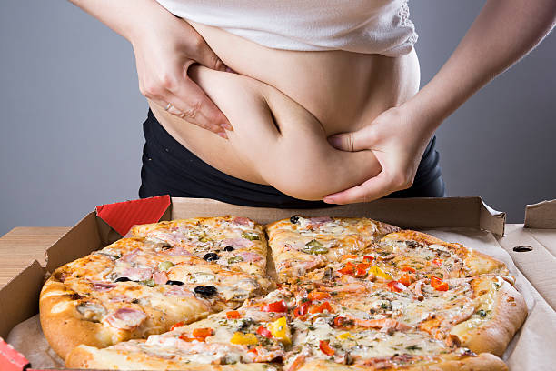 istock Fat woman with pizza, obesity concept 610568610