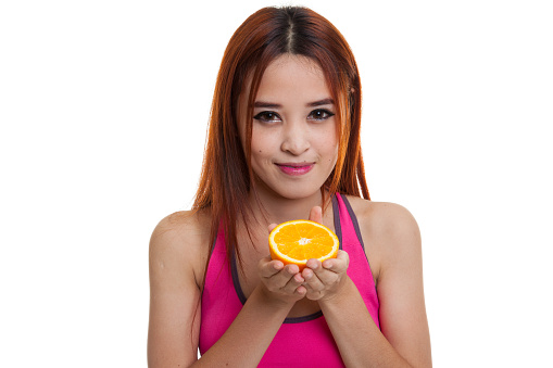 Beautiful Asian healthy girl with orange fruit isolated on white background.