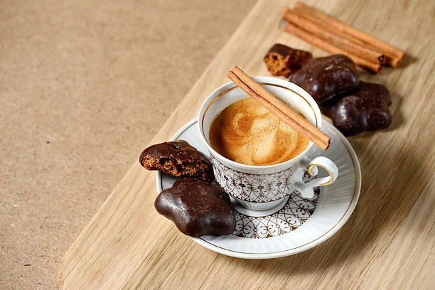 istock cup of hot coffee, cinnamon sticks, cookies and chocolate on 610570310