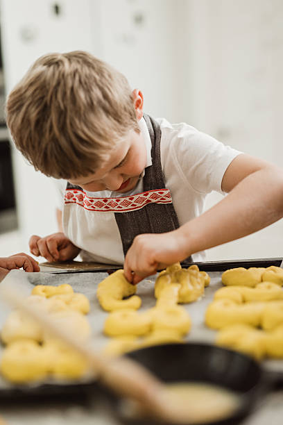 istock Little boy making saffron buns  for christmas 610571796