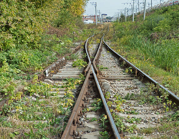 istock Two railways with rail shooter symmetrically receding to the hor 610575124