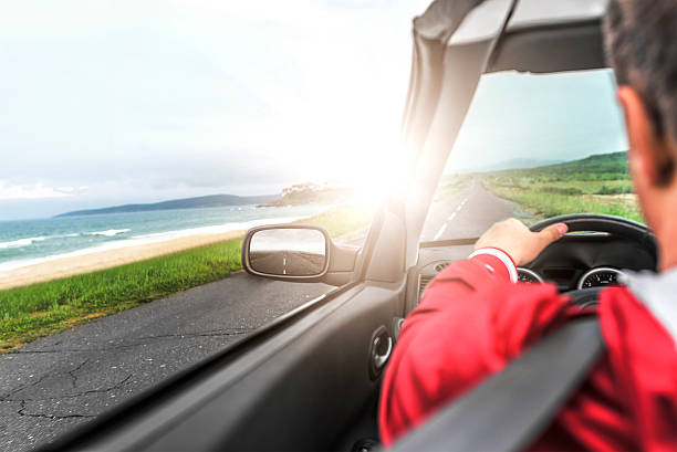 istock Man driving a convertible car. 610576160
