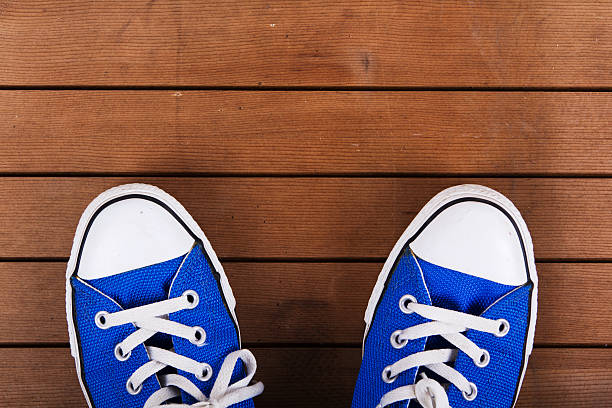 istock Old canvas shoes on a wooden floor 610577208