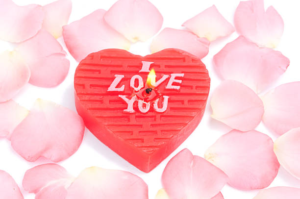 Heart shape candle and rose petals
