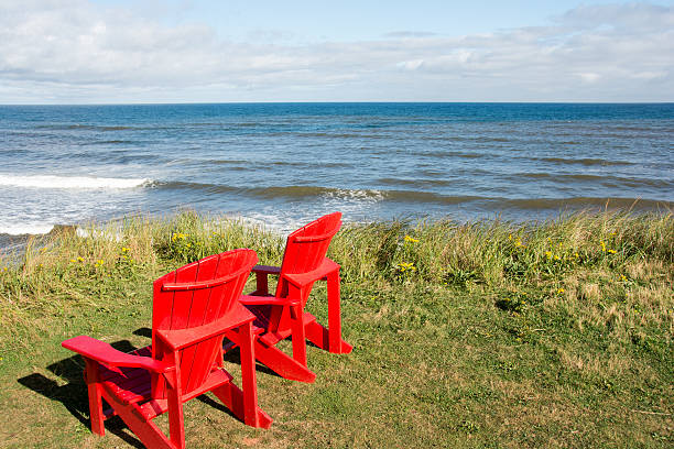 istock Shoreline plus red chairs  Prince Edward Island National Park 610579588