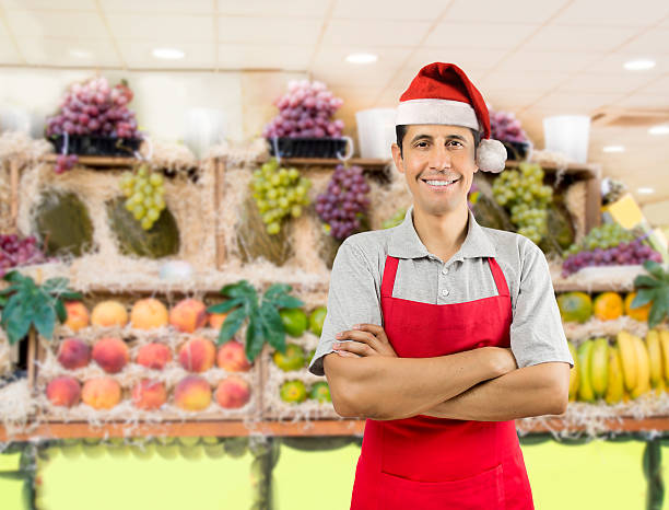 shopman with santa hat - supermarket sales clerk grocer apron imagens e fotografias de stock