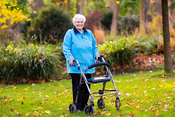 istock Beautiful senior lady with a walker in autumn park 610580556