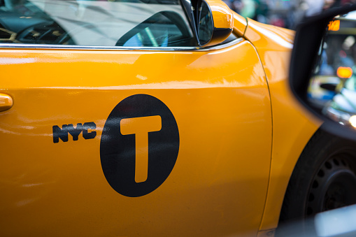 NYC taxi sign on yellow door