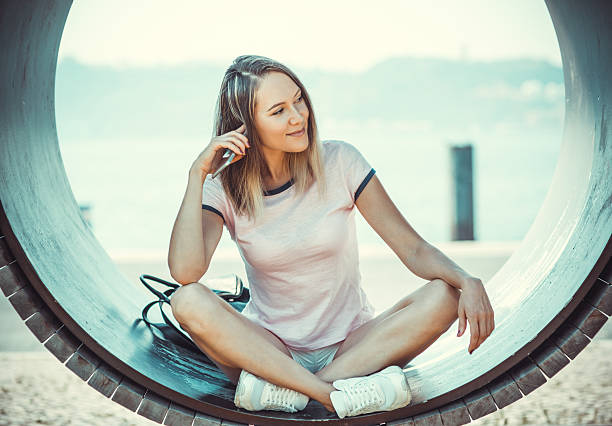 Photo which shows a beautiful young woman in real life, posing on the street
