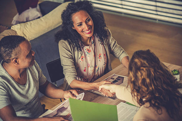istock Insurance agent shaking hands with a woman 610582364