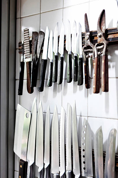 istock Set of knifes are hanging on a kitchen wall 610583064
