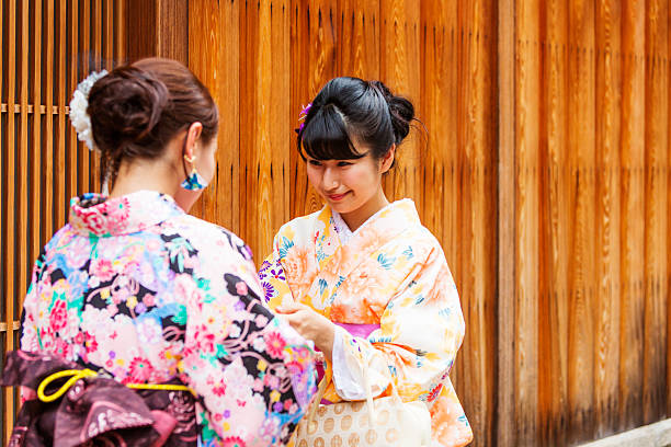 istock Traditionally Dressed Japanese Women in Kimonos Greet Each Other 610583454