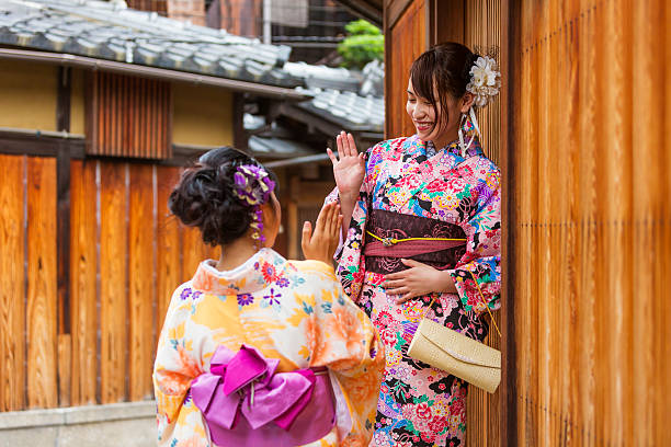 istock Traditionally Dressed Japanese Women in Kimonos Greet Each Other 610583464