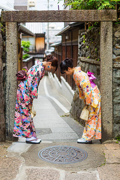 istock Traditionally Dressed Japanese Women in Kimonos Greet Each Other 610583468