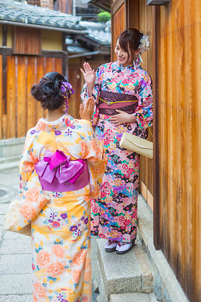 istock Traditionally Dressed Japanese Women in Kimonos Greet Each Other 610583474