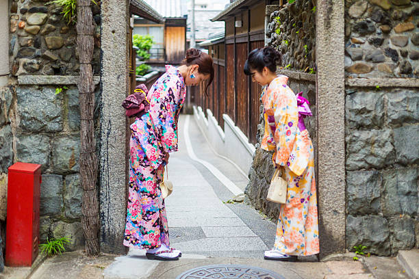 istock Traditionally Dressed Japanese Women in Kimonos Greet Each Other 610583480