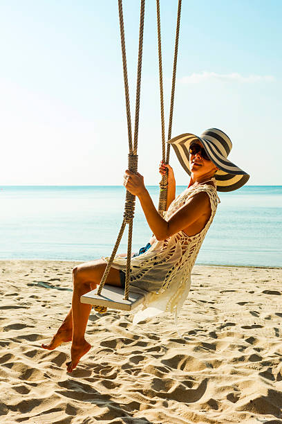 istock Woman at tropical swing 610583938