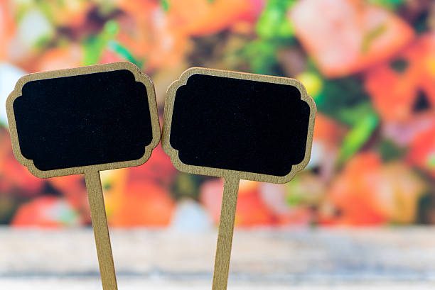 Wooden mini blackboard labels over vegetable salad background