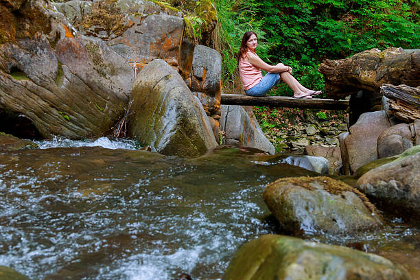 istock Woman sitting at the wood bridge 610585486