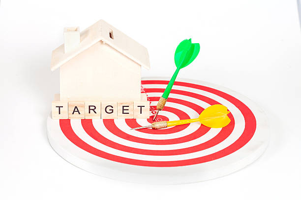 istock Miniature house on dart board 610647402