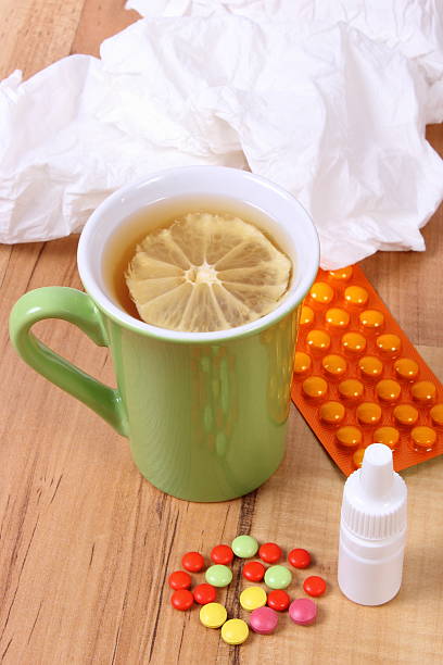 istock Pills and nose drops for colds, handkerchiefs and hot tea 610648242