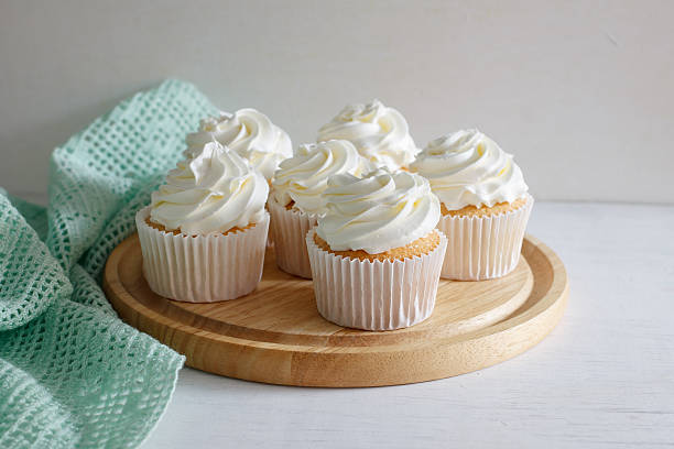 cupcake. sweet vanilla cupcake with buttercream put on wooden board, image soft tone. cupcake stock pictures, royalty-free photos & images
