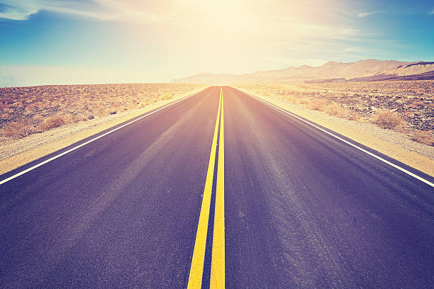 istock Vintage toned asphalt desert road against sun. 610651510