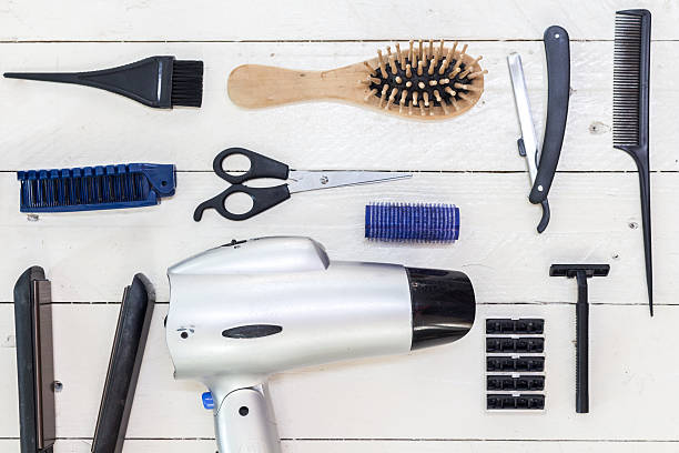 istock Hairdressing tools on white wooden table 610652030