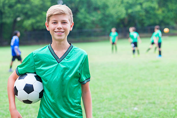 istock Handsome Caucasian soccer player with ball 610653114