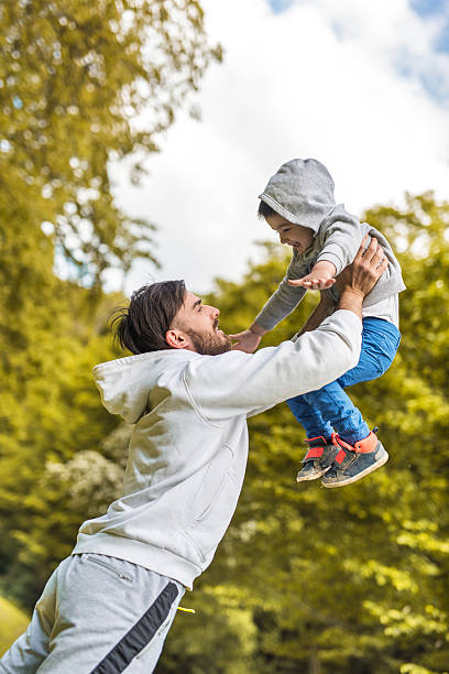 istock Playful father and son having fun together in nature. 610653344