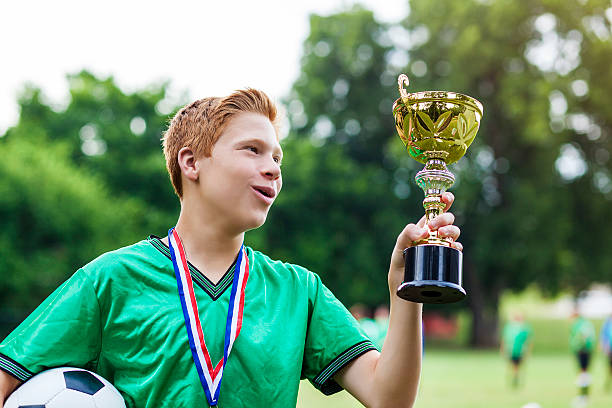 istock Caucasian soccer player admires trophy 610655002