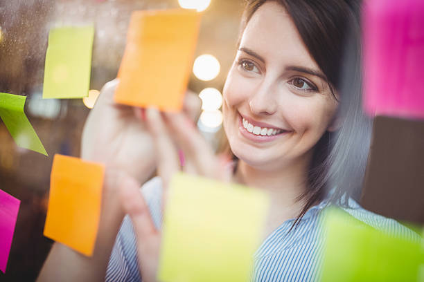 istock Creative businesswoman writing on sticky notes 610656484