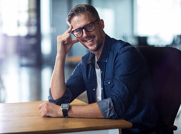 istock Portrait of man sitting in office 610656672