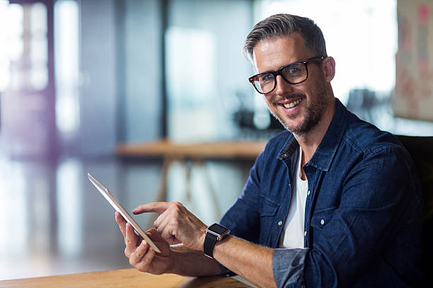 istock Portrait of smiling man using digital tablet 610656746