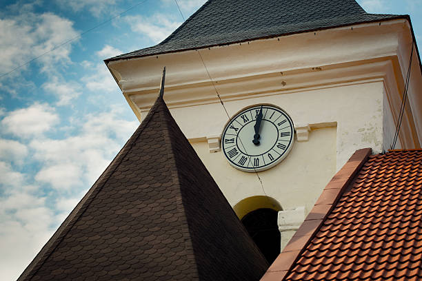 Tower old clock on background of blue sky with clouds