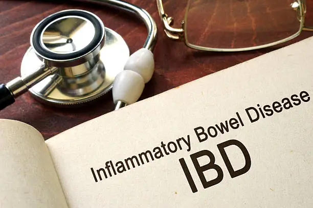 Photo of Book with words inflammatory bowel disease IBD on a table.
