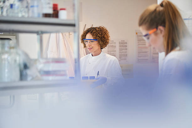 istock female scientist walking through the lab 610662844