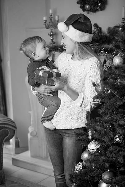 istock Young mother in Santa hat with baby son 610662912